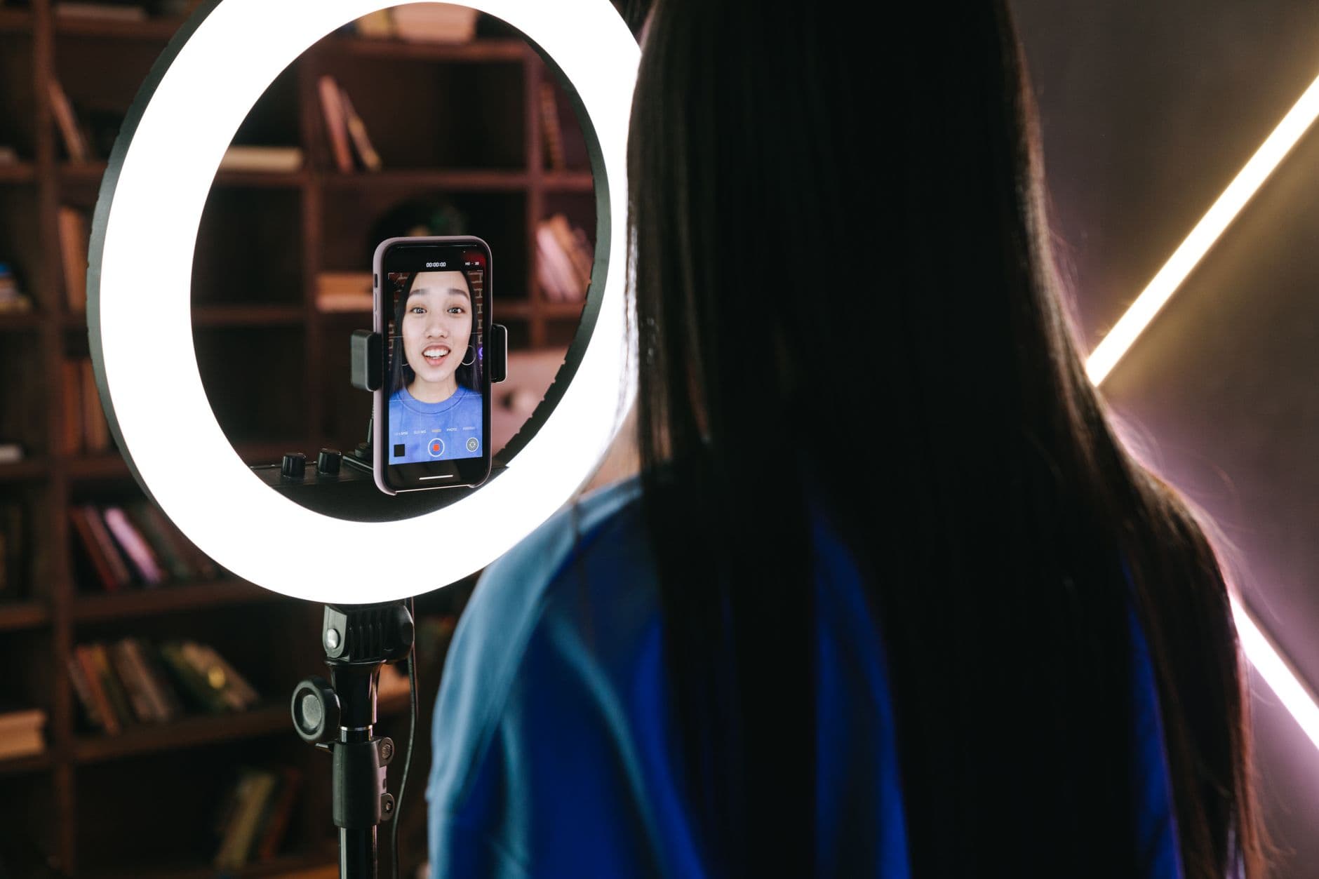Creator recording a vertical video with a smartphone and ring light